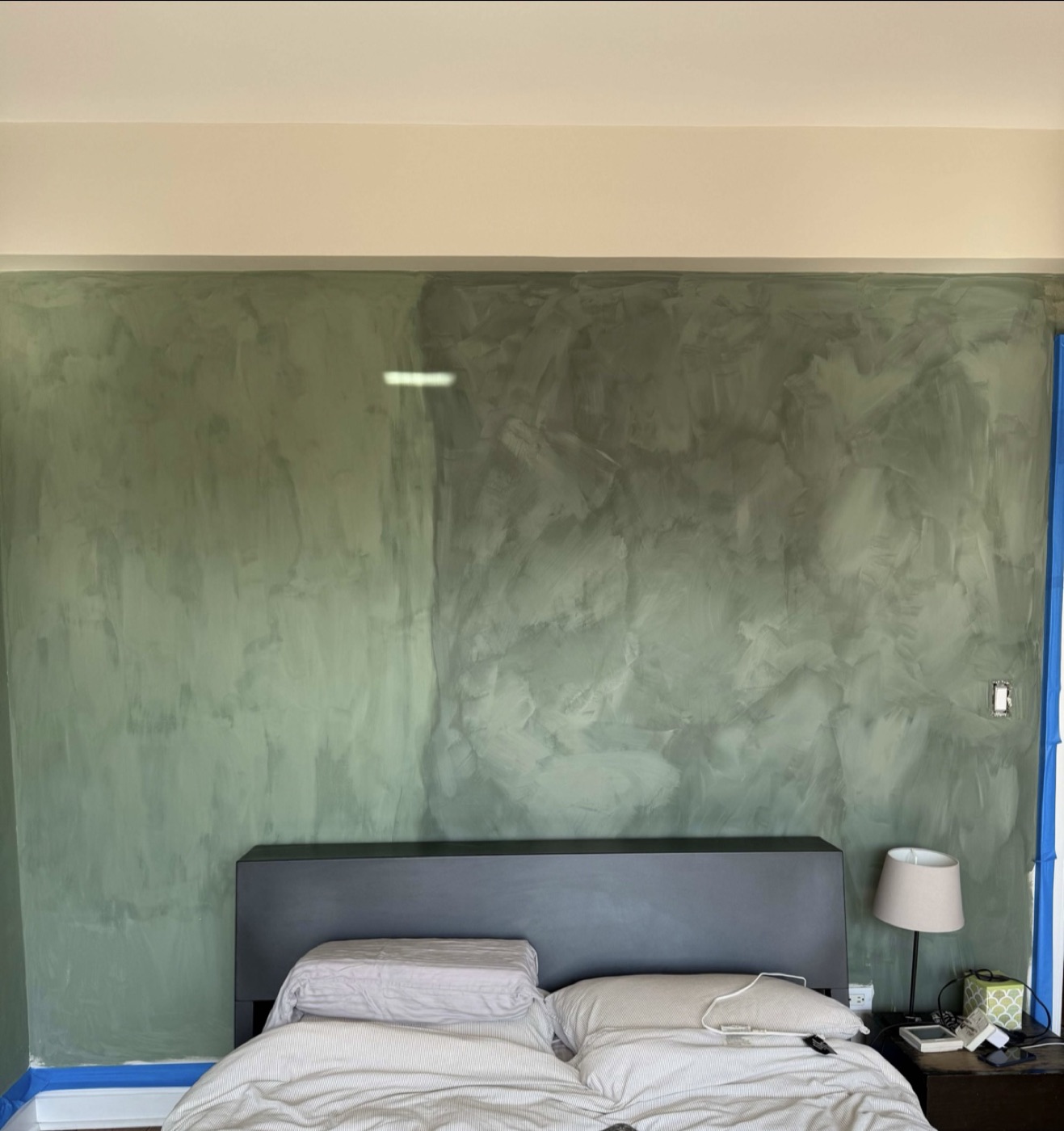 Patchy, uneven wall in a Greenwich Village bedroom before Limewall & Co. refinished it